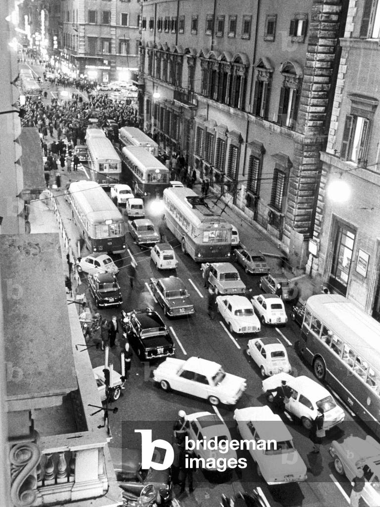 Traffic jam in via del Corso due to a demonstration, Rome, 1968 (b/w photo)