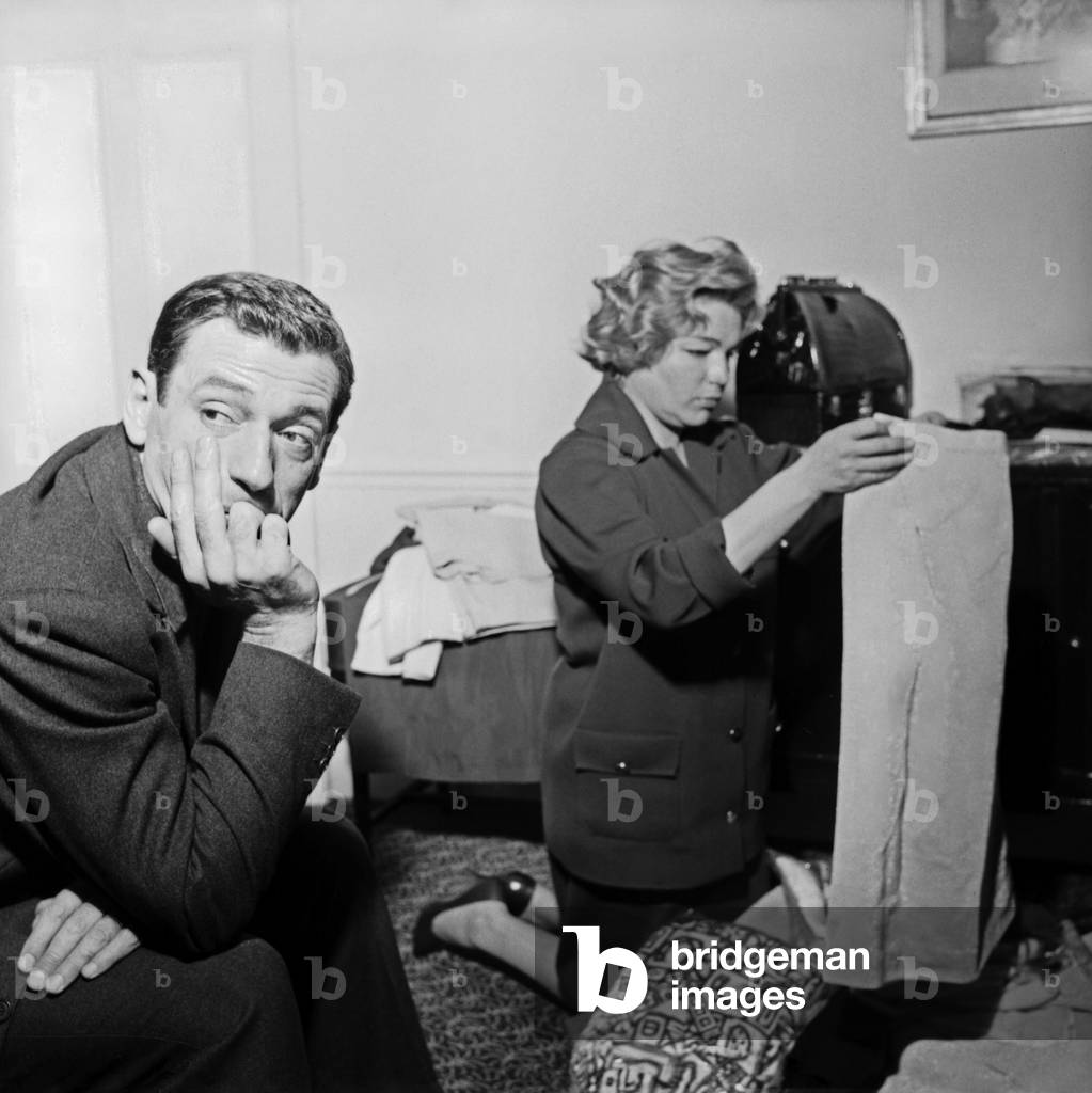 Yves Montand and Simone Signoret packing the luggages at 12th Cannes Film Festival, 1959 (b/w photo)