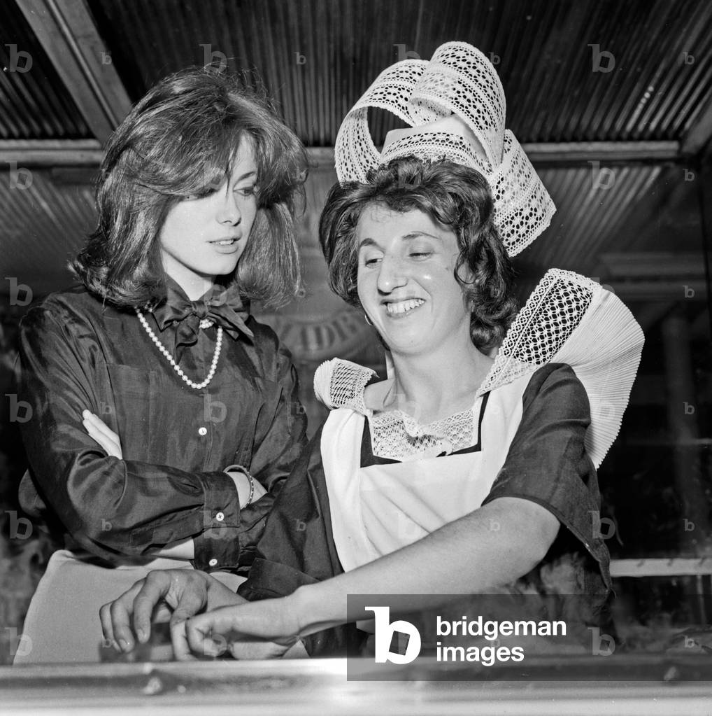 Catherine Deneuve with a cook of crepes from Brittany, Paris, 1961 (b/w photo)