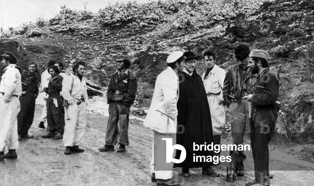 A group of Italian partisans talking to a priest in the hinterland of Reggio Emilia, 1944 (b/w photo)