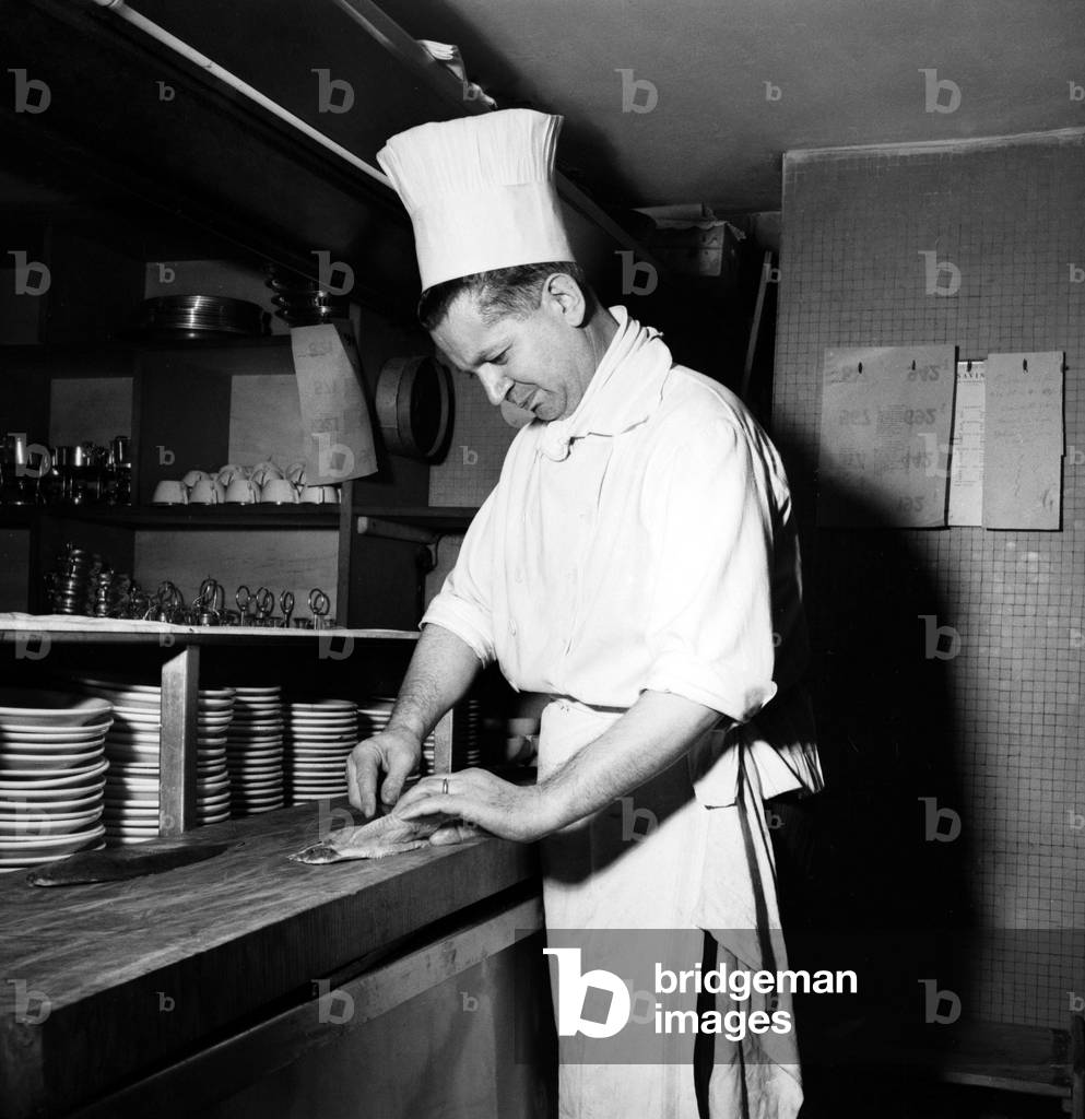 Chef Giuseppe Pirovano in the kitchen of the Savini restaurant, Milan, Italy, 1951 (b/w photo)