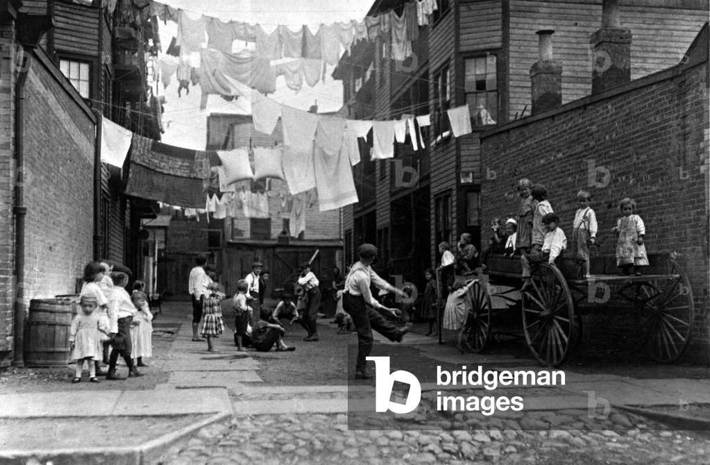Children of immigrants play in the streets of working-class neighbourhoods, Boston, USA, 1909 (b/w photo)
