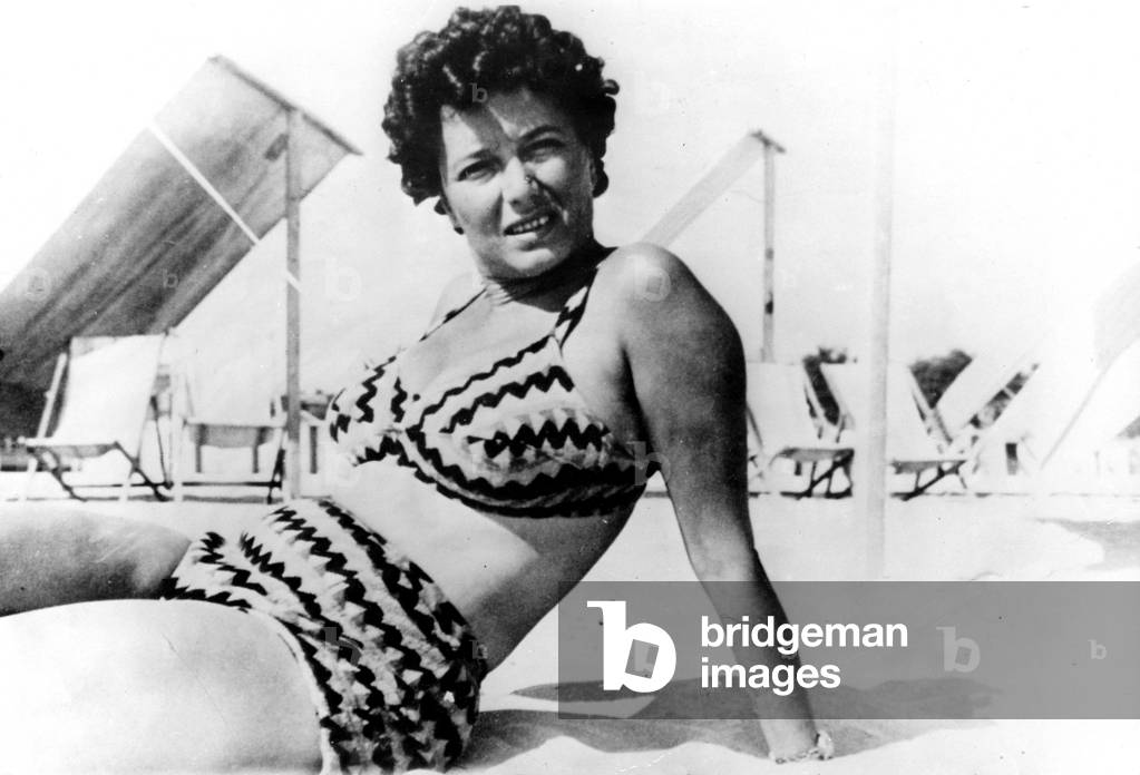 Clara Petacci in a bathing suit sunbathing on the beach at Ostia near Rome, 1938 (b/w photo)