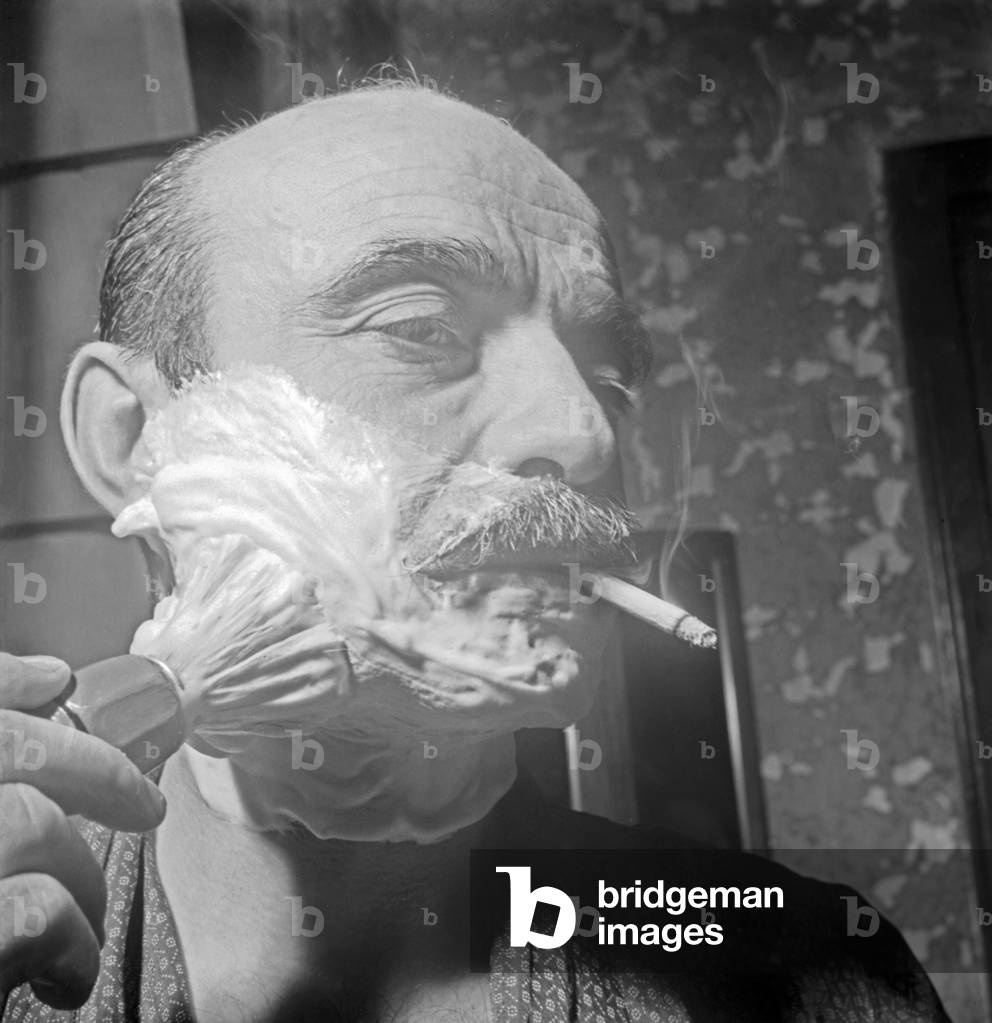 Lucio Fontana shaving his beard, Venice, Italy, 1950 (b/w photo)
