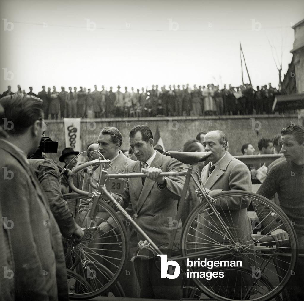Gino Bartali presents his bike to the controls at the Milan Sanremo race, Italy, 1948 (b/w photo)