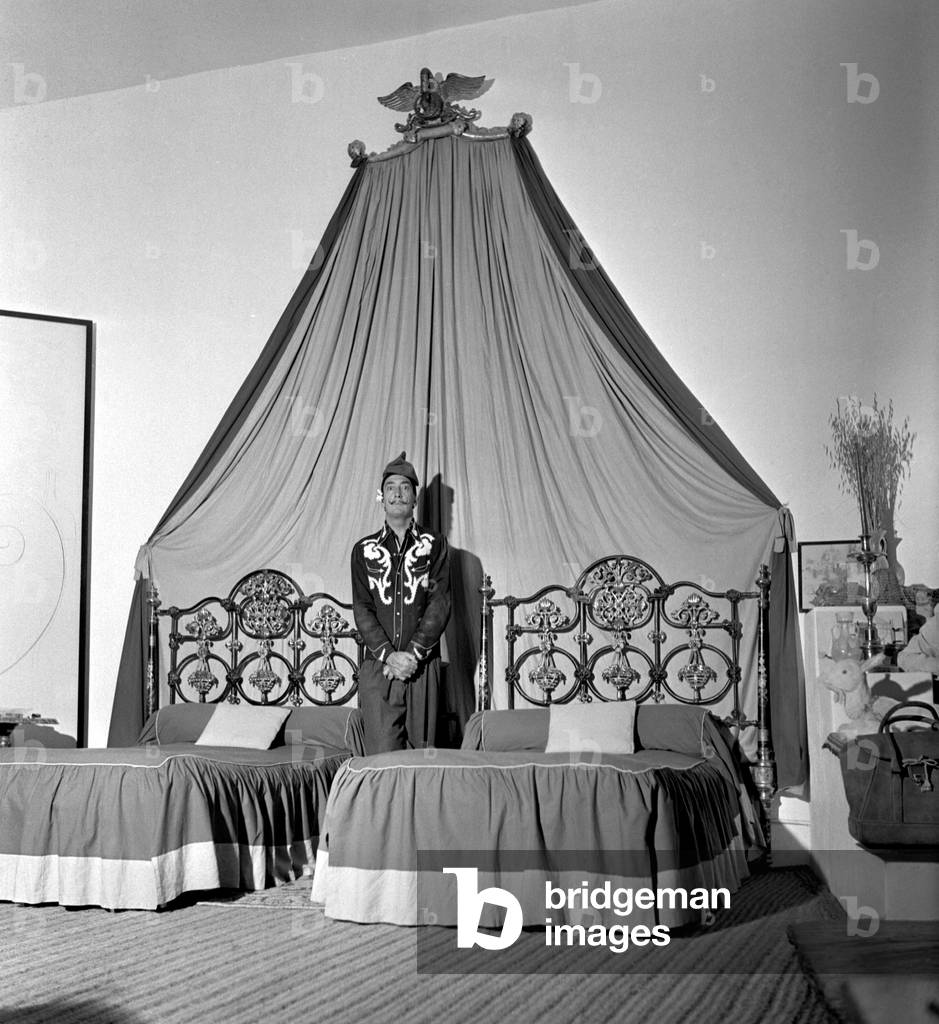 Salvador Dali in his bedroom, Port Lligat, Spain, 1957 (b/w photo)