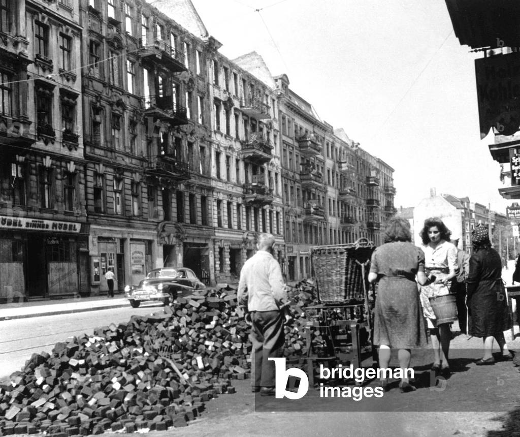 Coal bricks sold on city streets, Berlin, Germany, 1946 (b/w photo)