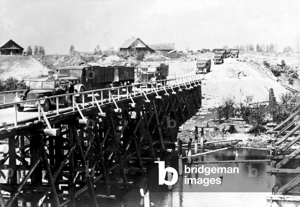 German motorised troops crossing a bridge over a river in Ukraine, 1941 (b/w photo)