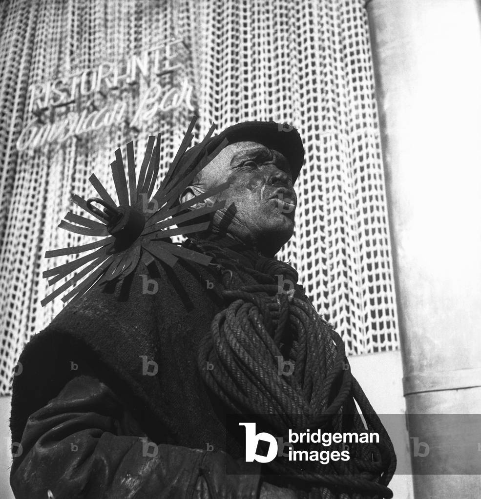 Chimney sweep with tallow on his face, Milan, Italy, 1946 (b/w photo)