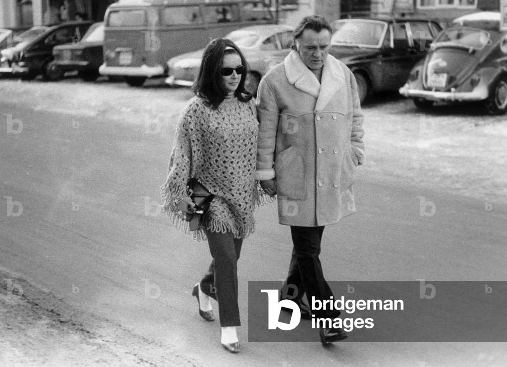 Elizabeth Taylor walking with her husband Richard Burton, Gstaad, Switzerland, 1969 (b/w photo)