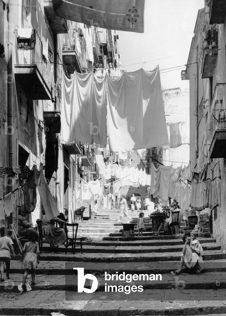 View of a street in a popular area of Naples, Italy 1960s (b/w photo)