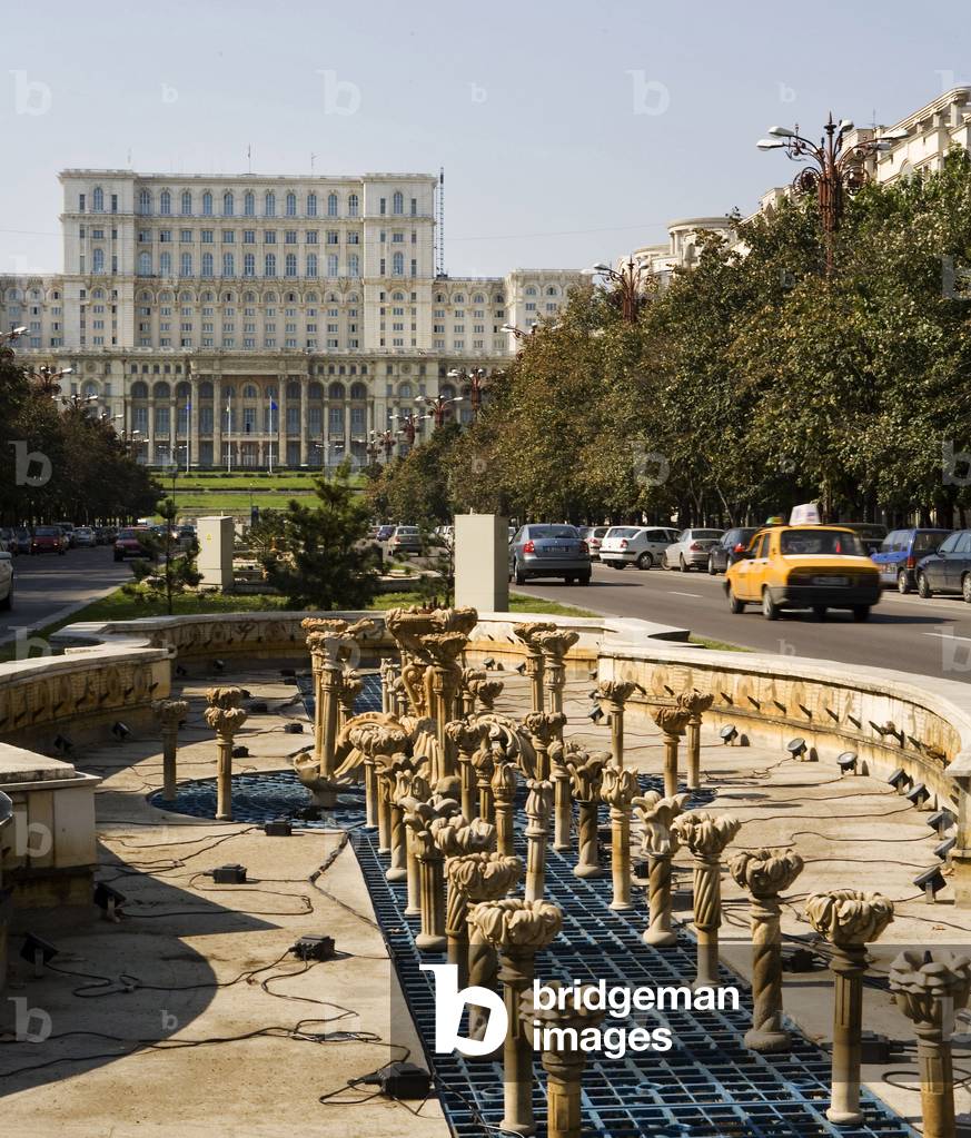 Public fountain on Boulevard Unirii in Bucharest, Romania, with the Parliament Palace in the background. Photography 10/10/05.