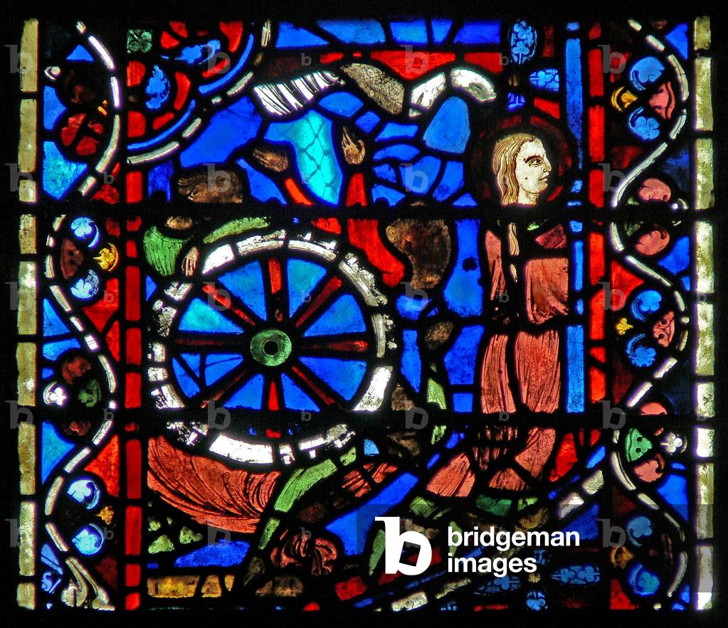 Window w53 depicting a scene from the life of St Catherine: the torturers prepare the wheel for her ordeal. (stained glass)