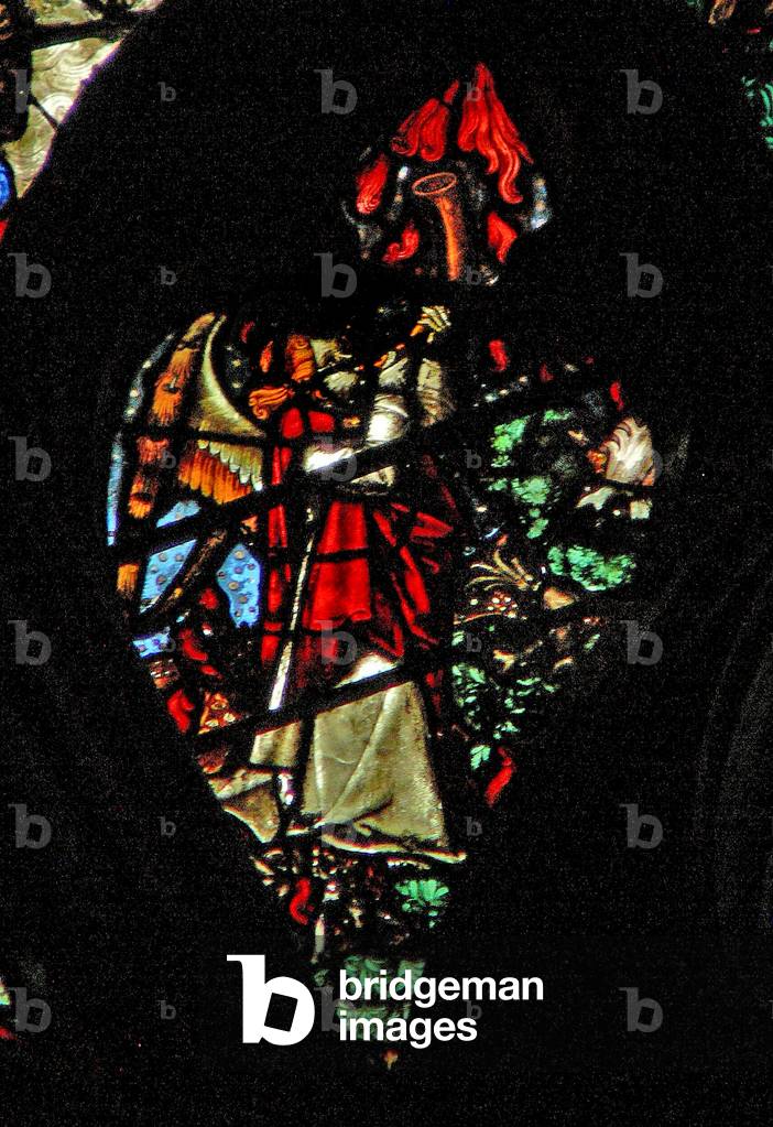 The west rose window depicting a scene from the Book of Revelation: sounding of the first trumpet. Hail and fire descend (8:6 7). (stained glass)