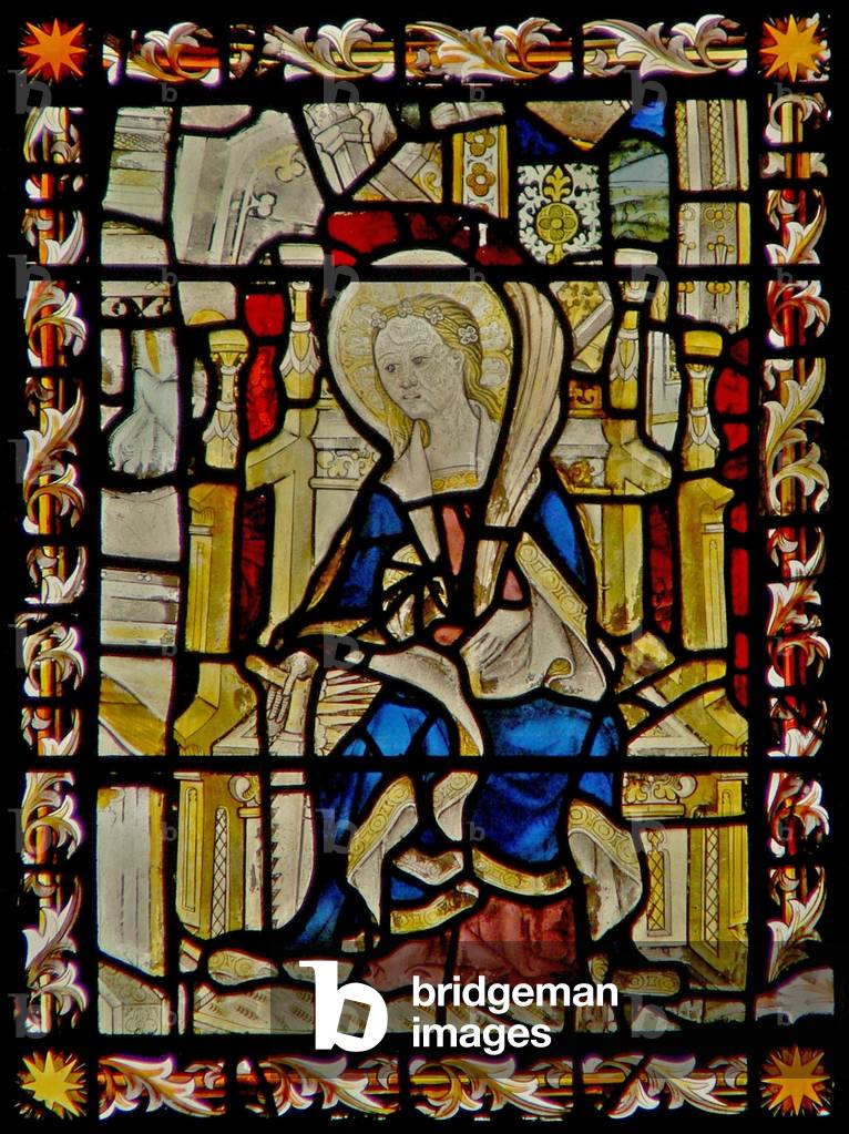 The east window depicting St Faith carryig her emblem the saw (stained glass)