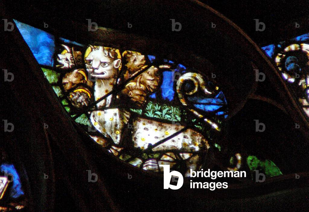 The west rose window depicting a scene from the Book of Revelation: beast with seven heads comes out of the sea (13:1) (stained glass)