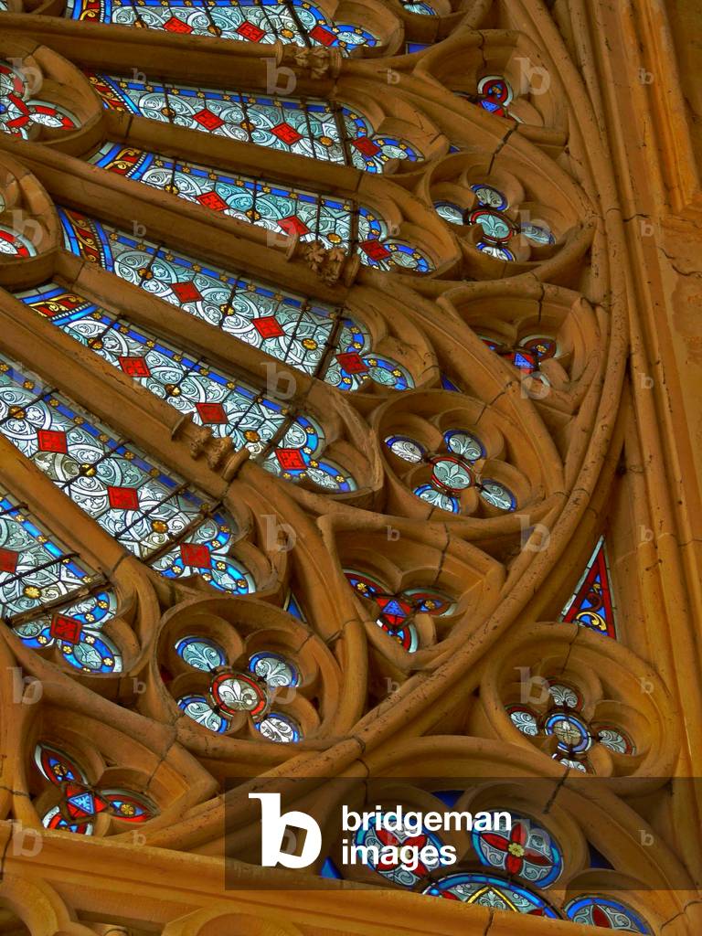 Depicting a section of the west rose of c.1240; the glass is modern (stained glass)