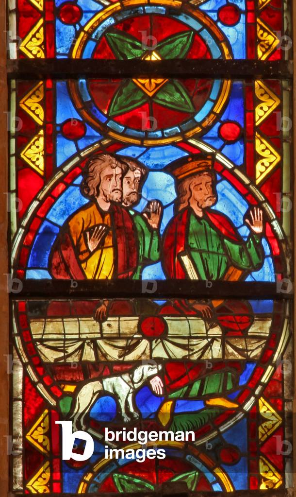 Window w213 depicting a scene from the life of St Thomas: at the banquet a dog brings in the cupbearer's arm (stained glass)