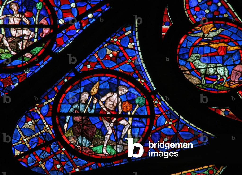 Window w115 depicting Adam delves while Eve spins (stained glass)