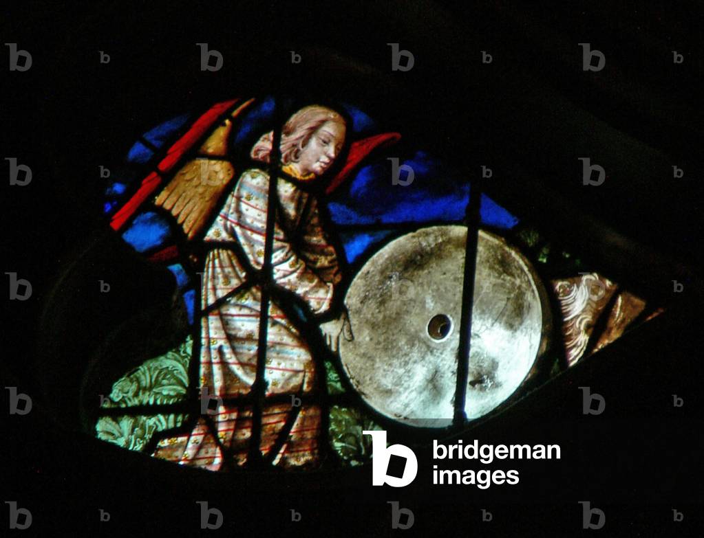 The west rose window depicting a scene from the Book of Revelation: A mighty angel casting a great millstone into the sea (18:21) (stained glass)