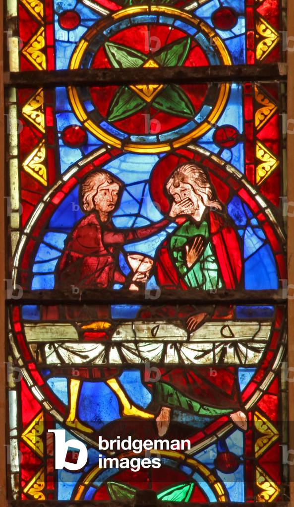 Window w213 depicting a scene from the life of St Thomas: the saint at a marriage banquet for the daughter of the king of India has his face slapped by a cupbearer (stained glass)