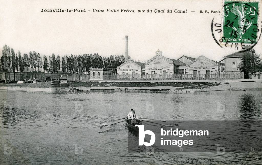 Factories Pathe Freres in Joinville-le-Pont (Joinville le pont): the factory buildings seen from the dock of the canal, with two young men in canoe - Manufacture of cylinders for phonographs and cinematographic company - cinematographers - cinema, cinematographer - postcard BF sent in 1915, early 20th century -