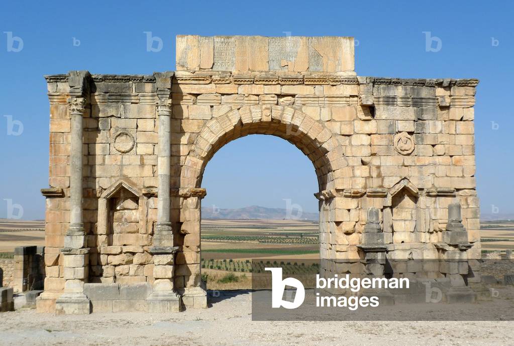 Roman ruins of Volubilis, Roman archaeological site, Unesco World Heritage near Meknes, Morocco - the Arc de Triomphe edifies by the municipality in honor of Emperor Caracalla and his mother Julia Domna in 217 AD - Roman archaeological site of Volubilis, UNESCO World Heritage Site, Meknes region, Morocco, North Africa, Africa - Arc of Triumph Photo by Patrice Cartier