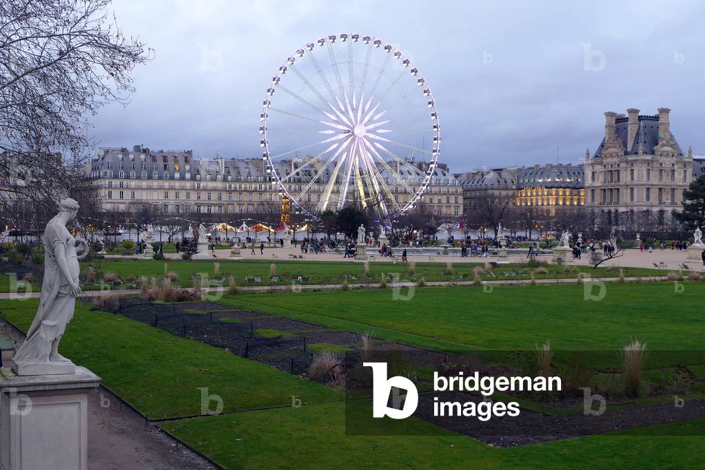 Paris, the Tuileries Garden in winter, in the evening, with Marcel Campion's Ferris Wheel, a 60 m high manege (fairground attraction) with 48 nacelles. On the right, the Pavillon de Marsan (Palais du Louvre) - photo Patrice Cartier January 2020