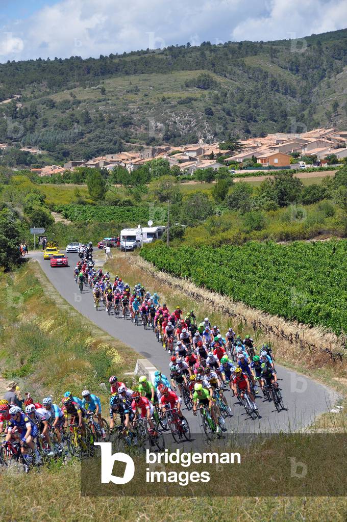 Tour de France cyclist 2016: passage of the peloton of runners in the vineyards of Minervois in front of the village of Caunes-Minervois - Languedoc Midi-Pyrenees, Occitanie - cycling, sport, bike - photo Patrice Cartier - see Tour de France in 1936 (80 years ago): GUT4440 a 4442 -