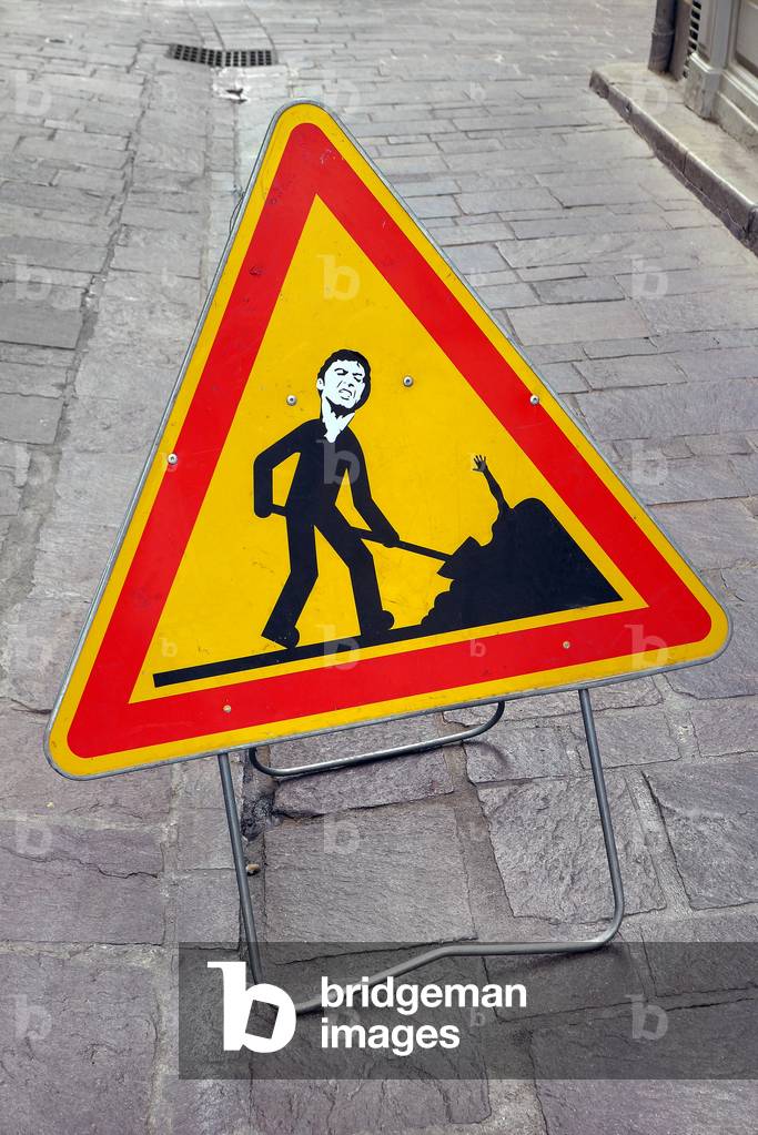 Work sign hijacked with stickers in Beziers, 2021 (photograph)