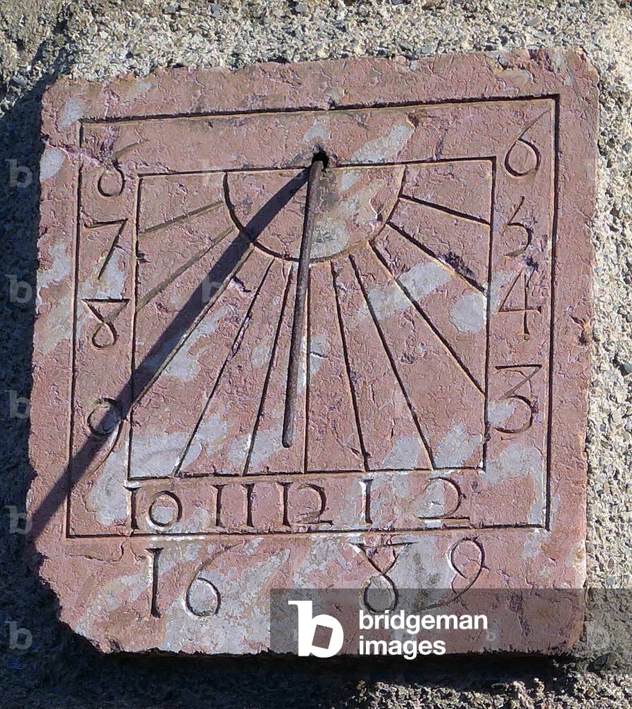 1689 sundial (late 17th century) in pink marble on a facade of Caunes-Minervois (Aude, Minervois, Languedoc)