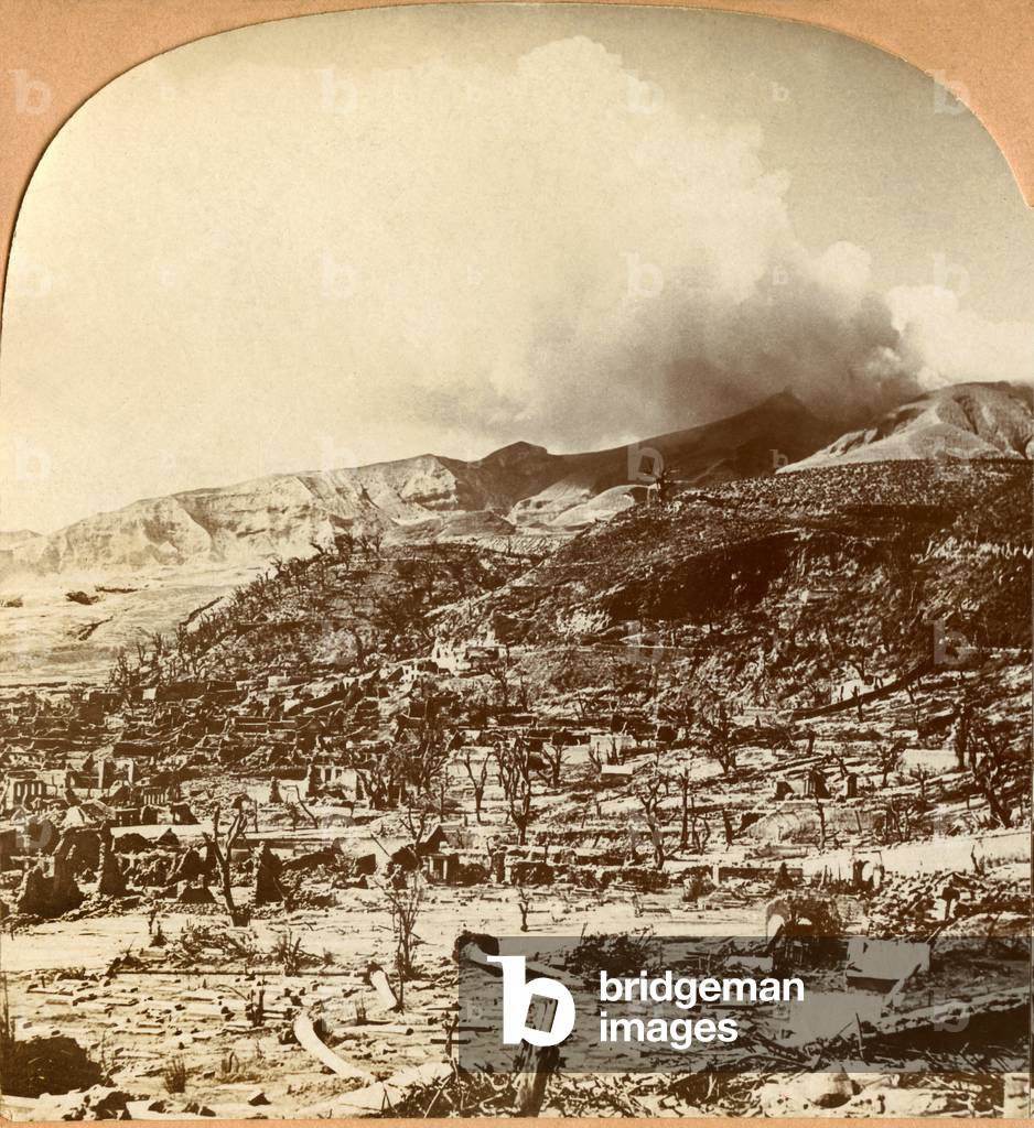 View of Saint Peter (Saint Pierre, St Pierre, Martinique) just after the destruction of the city by the eruption of the volcano of Mont Pele or Montagne Pelee on May 8, 1902 - ruins, cemetery of the Anchorage in the foreground and volcanic smoke in the background - photograph: print of period after a stereoscopic plate made during the disaster after the burning cloud -