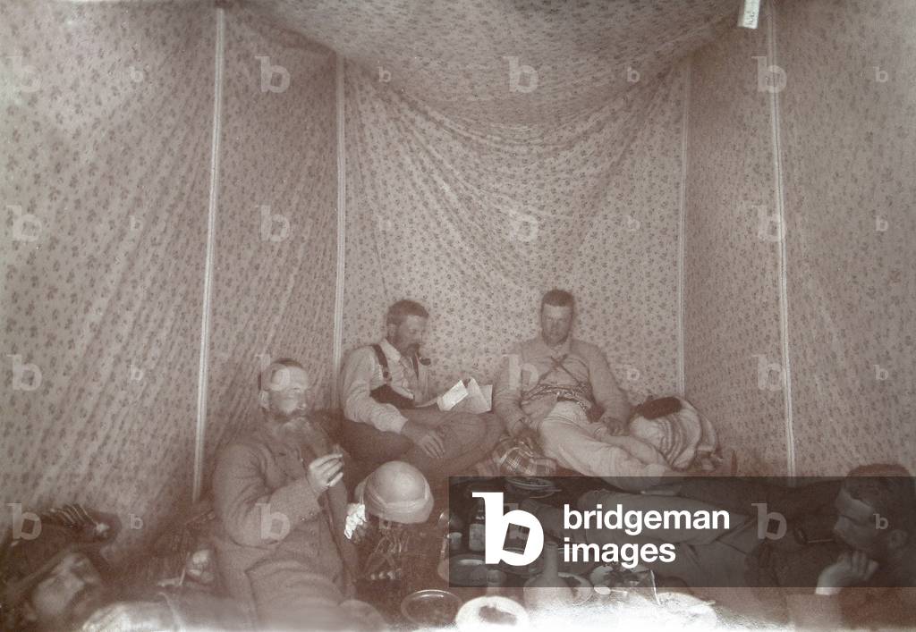 Members of the Arabah Survey expedition relaxing in their tent, 1883 (b/w photo)