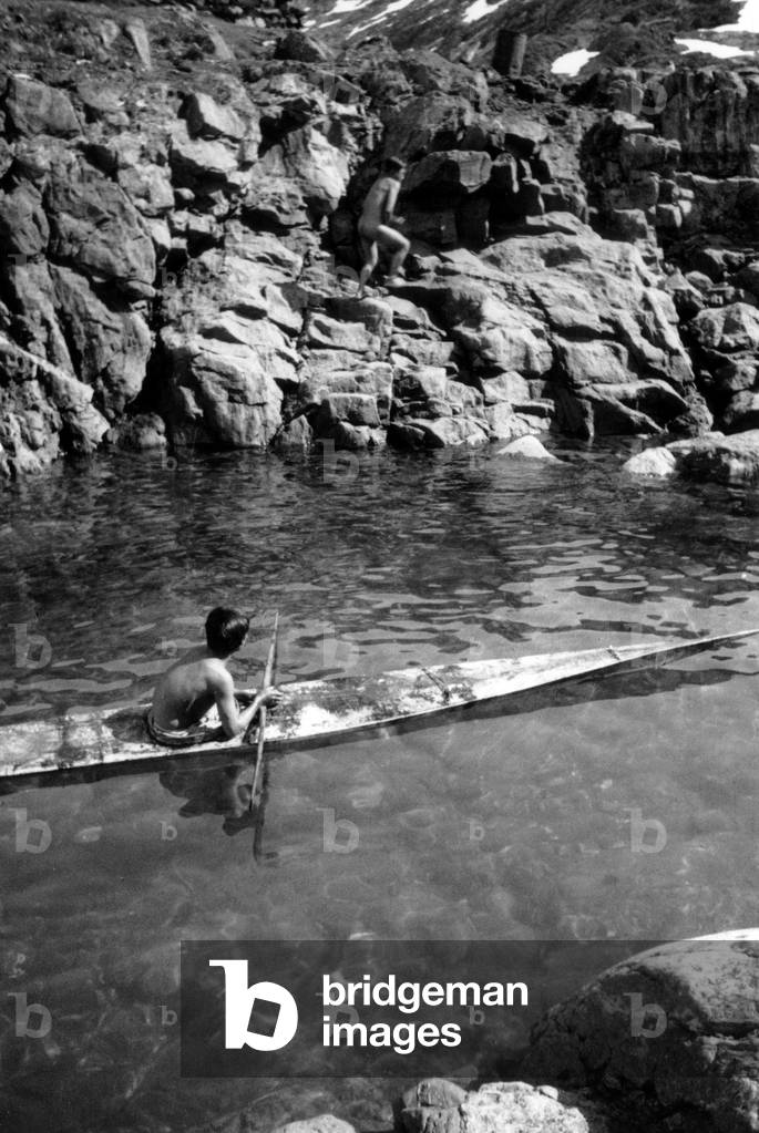 An inuit in a kayak, during polar expedition in Greenland, Kangerdlugssuatsiak, Autumn, 1936 (b/w photo)