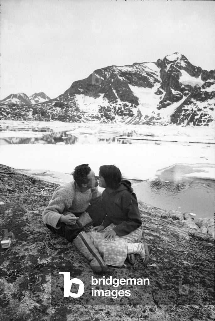 On the edge of the fjord, Paul-Emile Victor and his companion Doumidia make a kratouna kiss, a kiss of a white man, on the cheeks, Kangerlugsuatsiak, Greenland, July 1937 (b/w photo)
