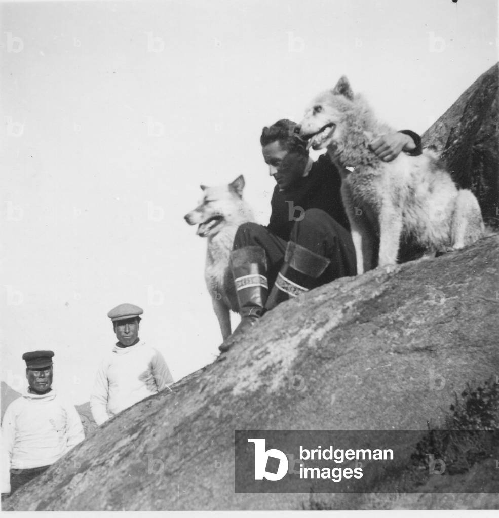 Paul-Emile Victor with two Inuit and two of his dogs, Ammassalik, Greenland, Summer 1934 (b/w photo)