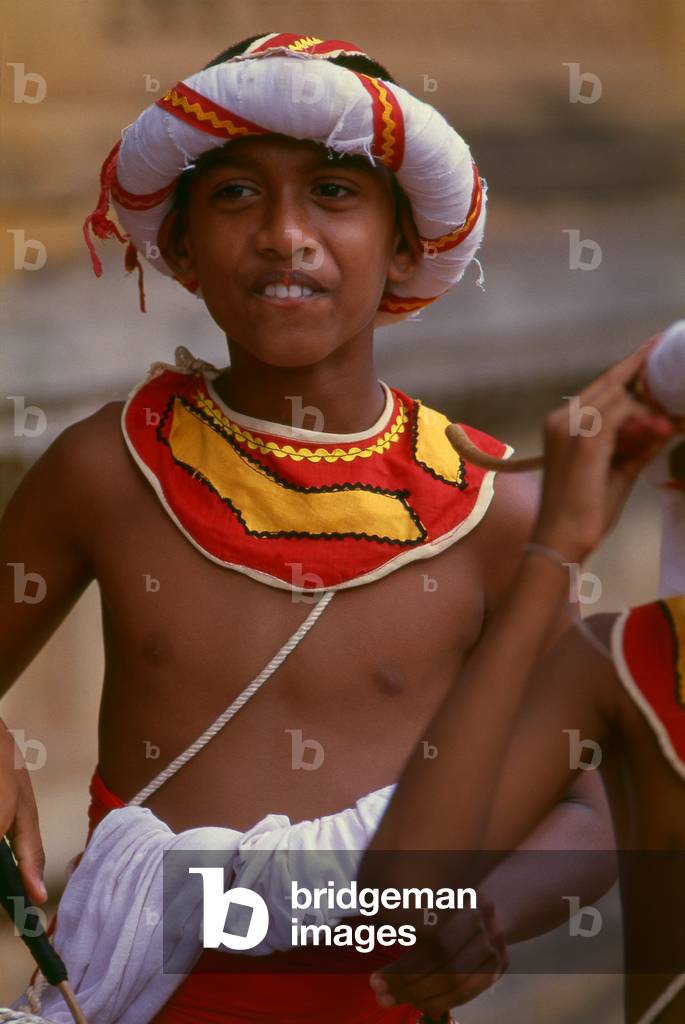 Sri Lanka: Traditional drummer boy at Kelani Temple near Colombo