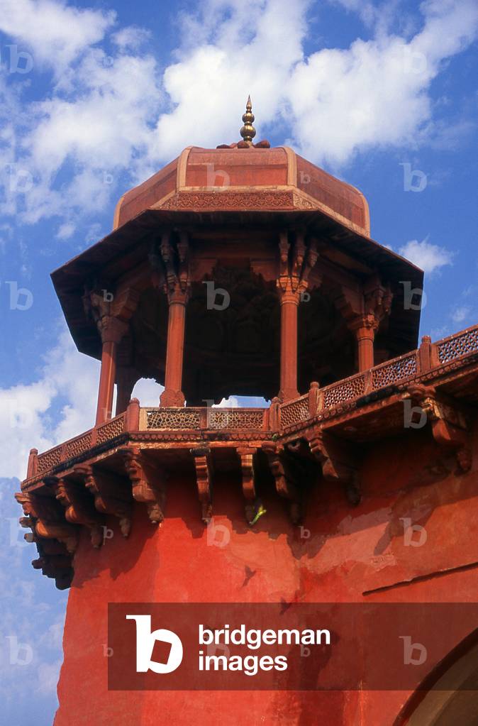 India: Parakeets fly passed a corner tower at the Mausoleum of Akbar the Great (1555 - 1605), third Mughal emperor, Sikandra, near Agra, Uttar Pradesh