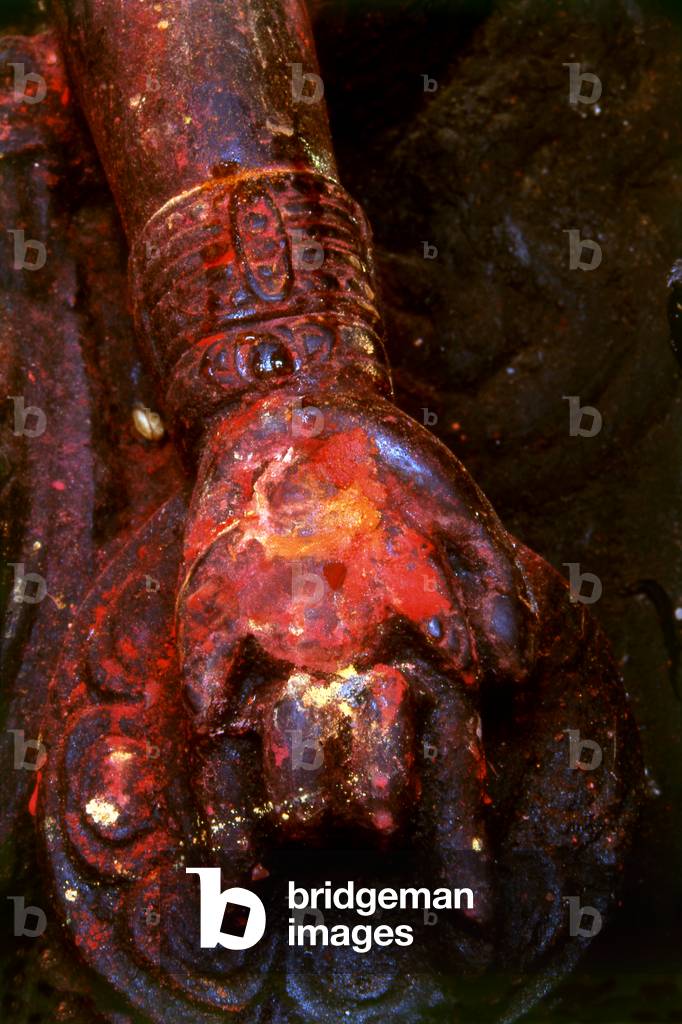 Nepal: A detail showing the arm of the Hindu god Vishnu holding a razor-edged discus (chakra), Durbar Square, Patan, Kathmandu Valley (1998)