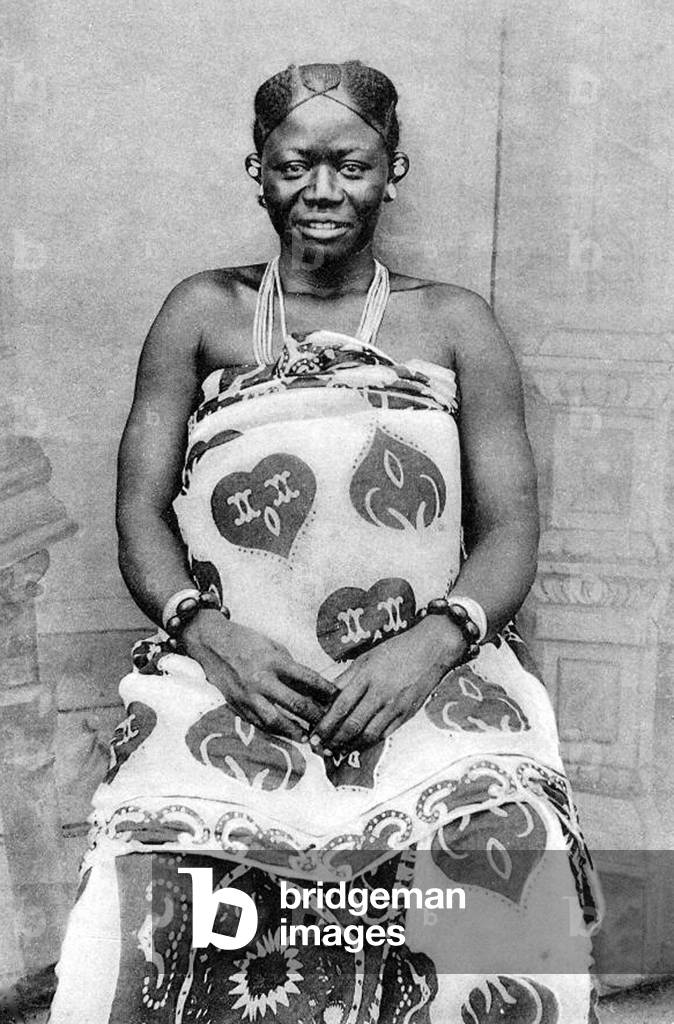 Tanzania / Zanzibar: Swahili woman posing in kanga wrap-around dress, late 19th-early 20th century