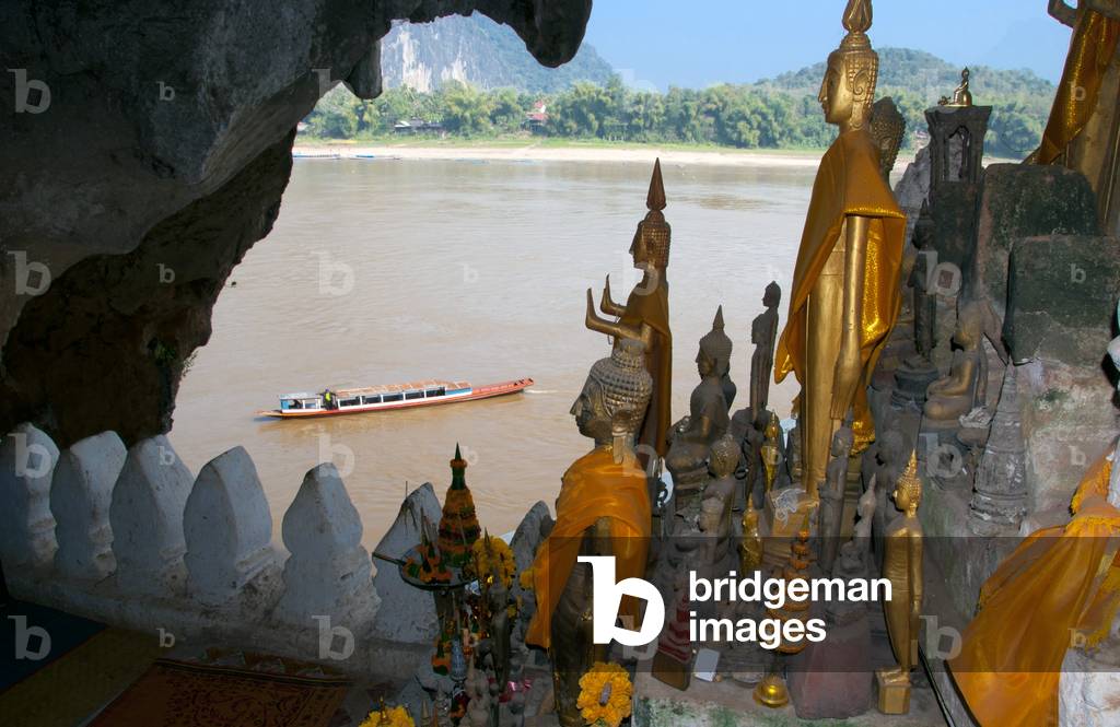 Laos: Buddha figures line the inside of the Pak Ou Caves overlooking the Mekong River, Luang Prabang