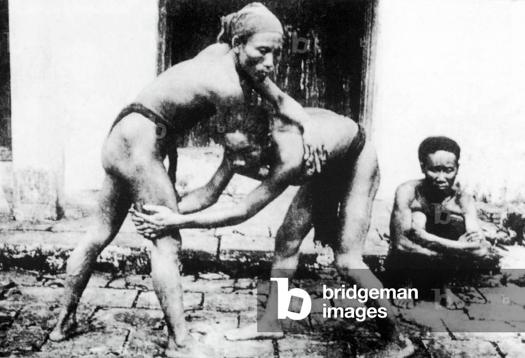 Vietnam: Wrestlers pose for a photograph in Hanoi (early 20th century).