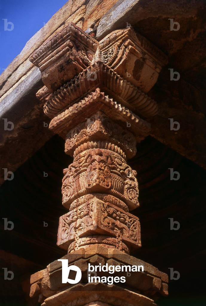 India: A crafted stone pillar in the Quwwat-ul-Islam Mosque at the ancient Qutb Minar complex, Delhi