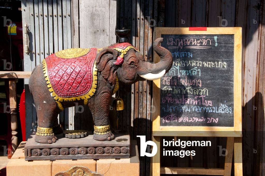 Thailand: Wooden elephant and menu outside a restaurant on Chai Kong Road, Chiang Khan, Loei Province