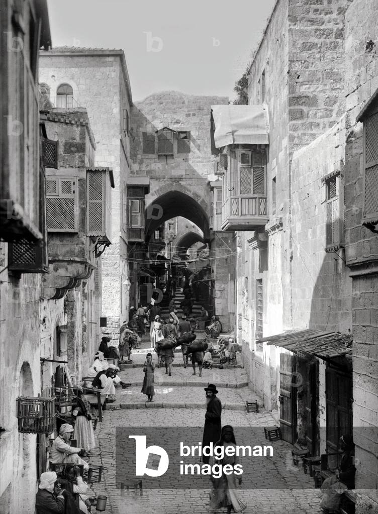 Palestine: Palestinian Arabs and a Jewish man on the street leading to the Mosque of Omar, Jerusalem, c. 1910