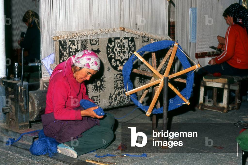 China: Uighur carpet weavers, carpet factory, Khotan, Xinjiang