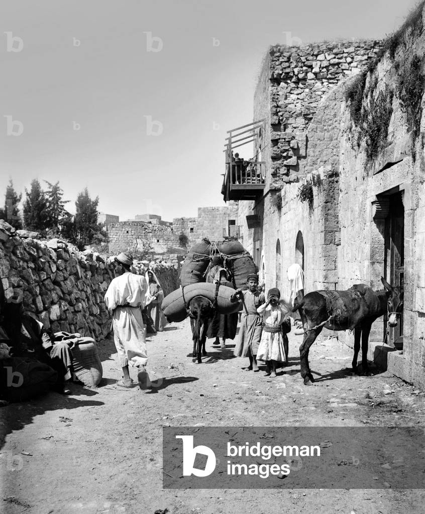 Palestine: Heavily-laden donkeys on a Ramallah Street, c. 1910