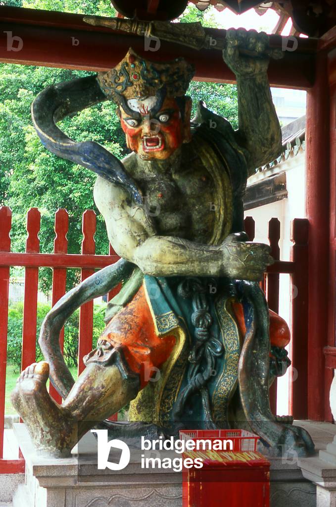 China: A temple guardian in the entrance gate of the Temple of Bright Filial Piety (Guangxiao Si), Guangzhou, Guangdong Province
