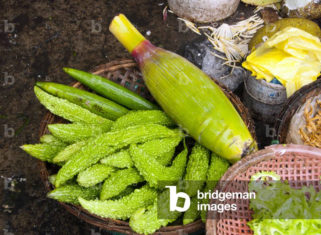 Vietnam: Bitter gourds and a banana flower bud in a fresh market in Hue