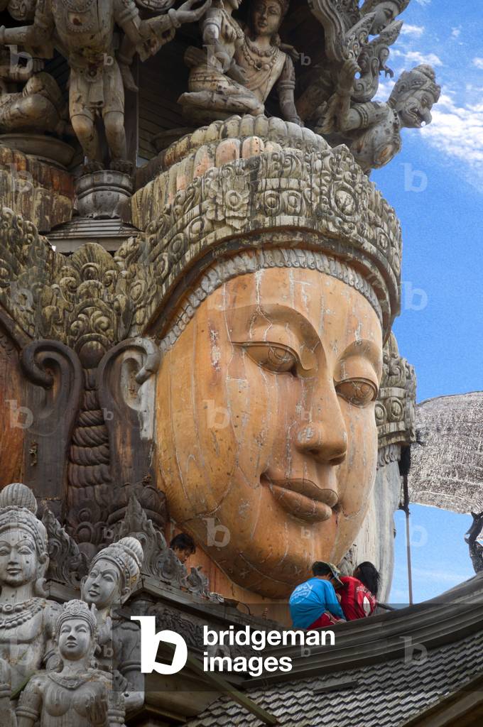Thailand: One of the four faces of Brahma with a worker on the roof, Sanctuary of Truth, Pattaya, Chonburi Province